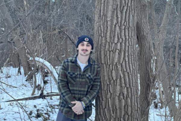 Max Hertz standing next to tree