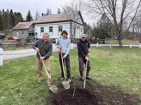 Dominick Hale planting a tree in Cabot